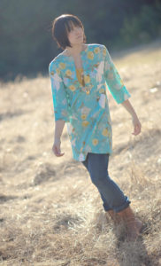 A blue floral schoolhouse tunic worn over a yellow tank and jeans