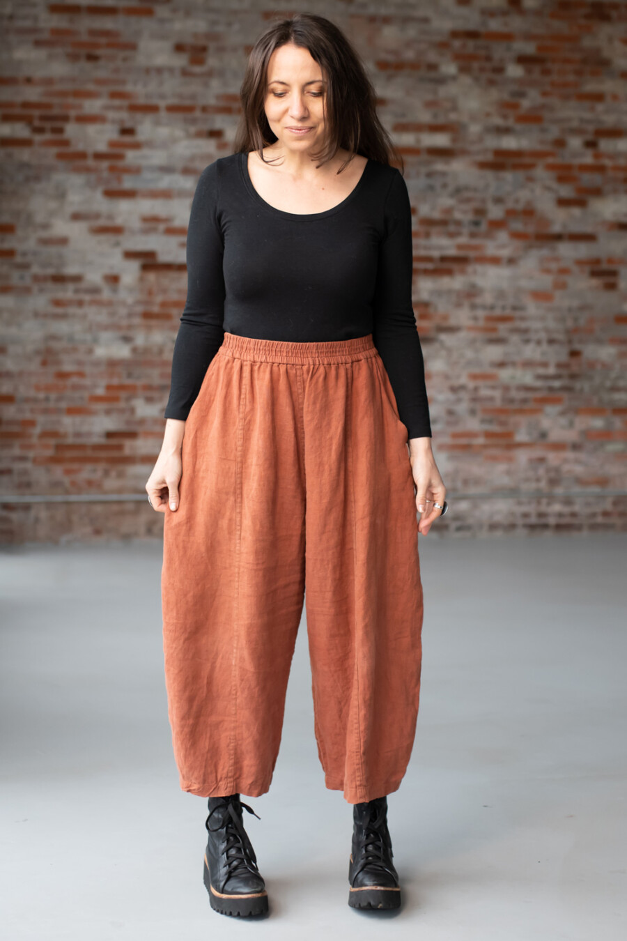 Meg McElwee wearing a black Stasia Tee and clay Arthur Pants
