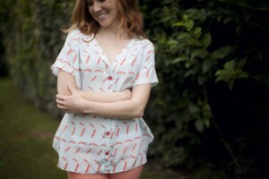 A blue Aida Top with pink feathers worn with pink pants