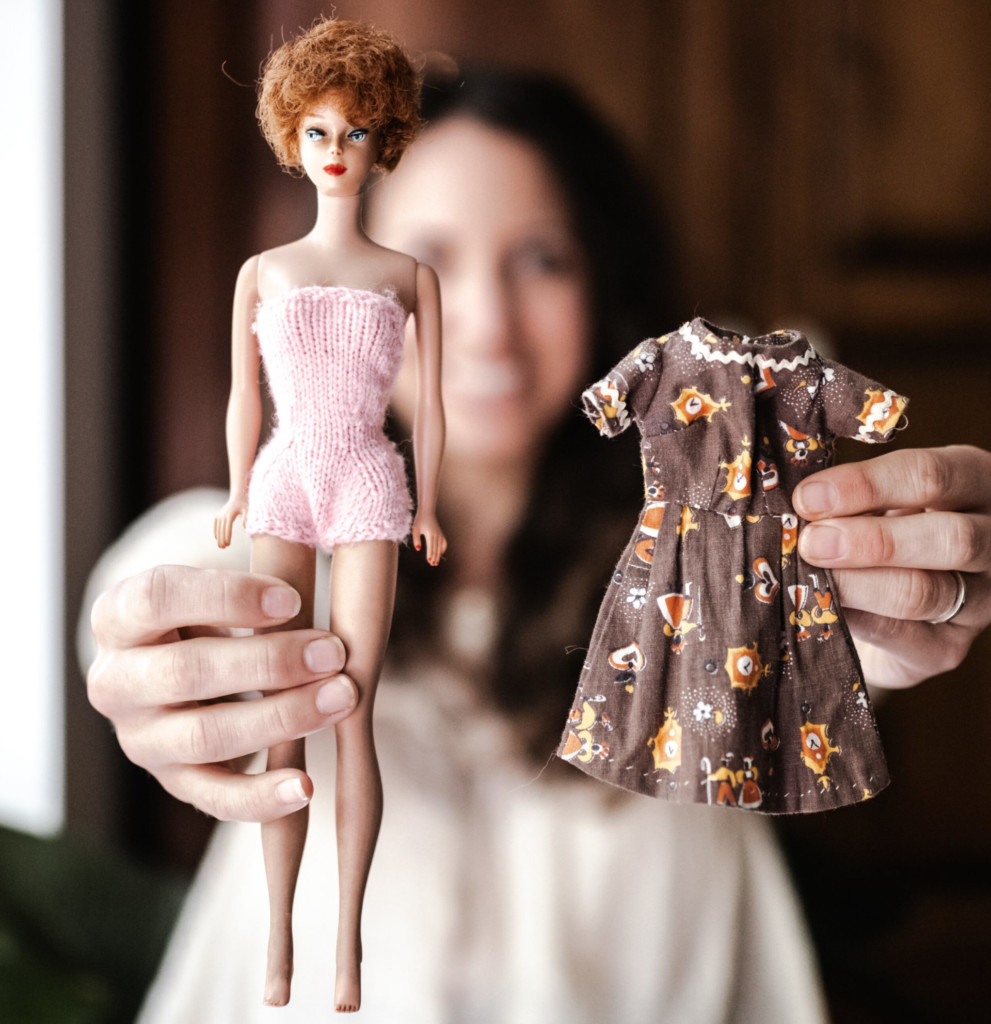 Playing with (tiny) clothes 2 Meg holding a vintage Barbie doll with a brown dress made by her great-grandmother