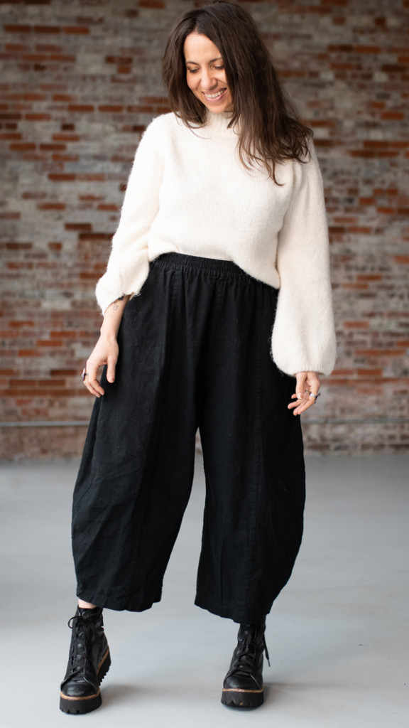 Meg wears a white top with black Arthur Pants