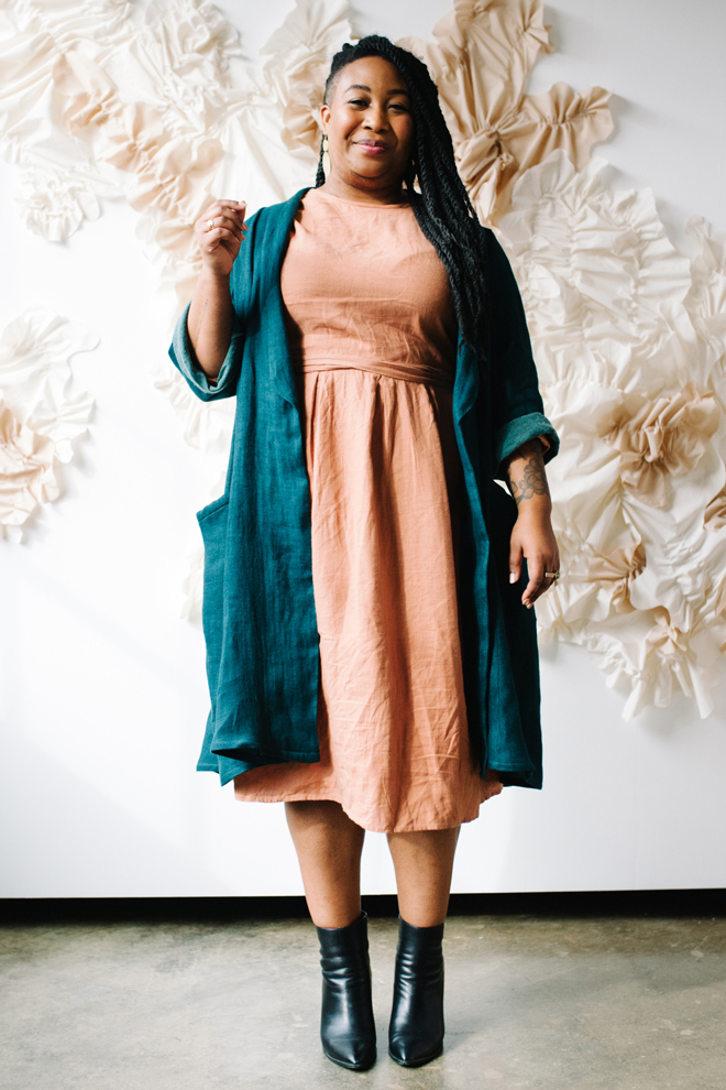 Ashley wears a peach dress and a blue Lichen Duster