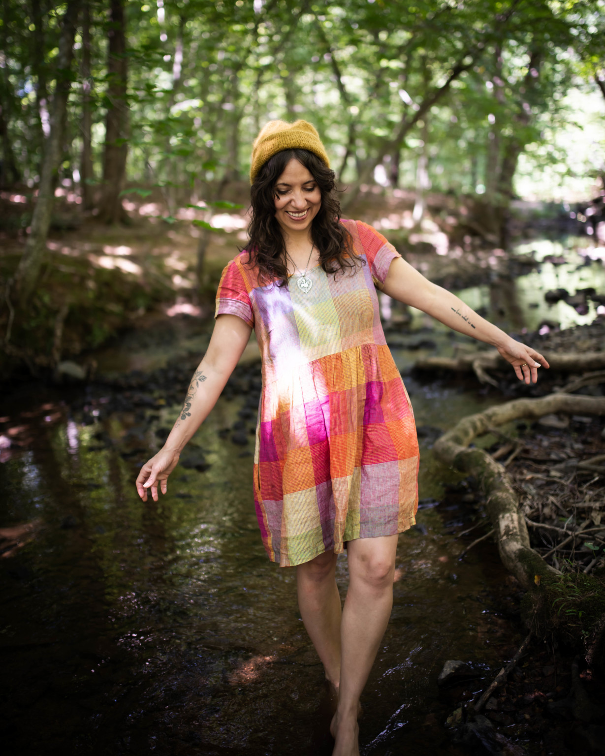 Meg wears a short sleeved rainbow Hinterland dress