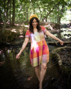 Meg wears a short sleeved rainbow Hinterland dress