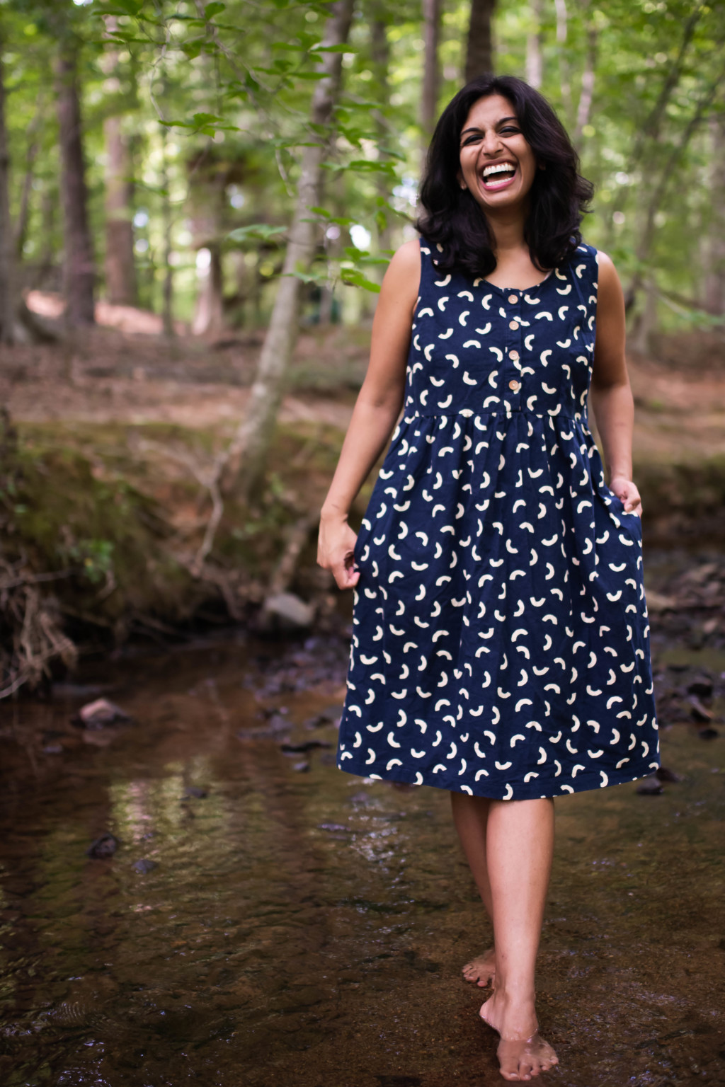 Sophia wears a navy printed sleeveless Hinterland dress