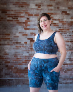 Shaerie wears blue ice dyed Limestone bike shorts and top