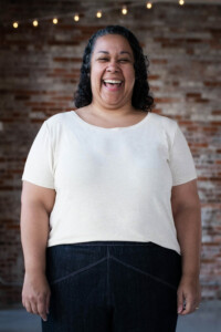 Sudi-Laura wears a white Bedrock Tee