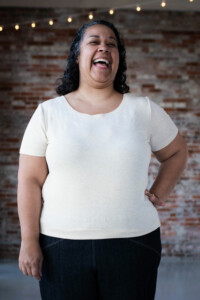 Sudi-Laura wears a white Bedrock Tee