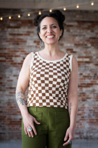 Meg in a checkered Bedrock Tee