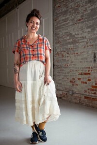 Meg wearing a red plaid, view a Joanie Top