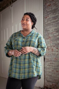 Ashley wearing a green plaid view b joanie top