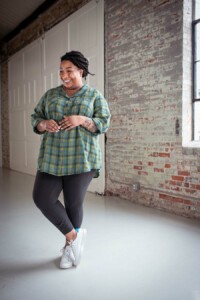 Ashley wearing a green plaid view b joanie top