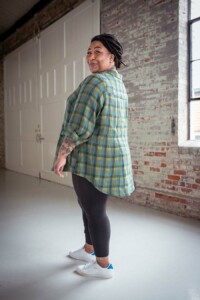 Ashley wearing a green plaid view b joanie top