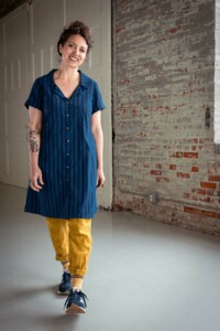 Meg wearing a blue, dress length version of the Joanie Top