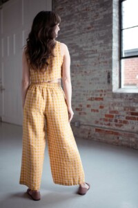 Meredith wears a pink and yellow gingham hinterland crop top and matching chanterelle pants.