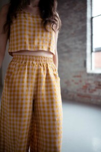 A close up on Meredith's yellow and pink gingham matching separates. A hinterland crop top and chanterelle pants.