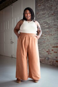 Ashley wearing striped view a chanterelle pants and a cream tank