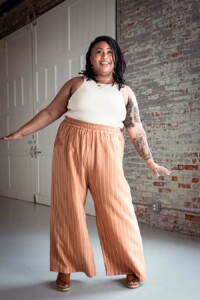 Ashley wearing striped view a chanterelle pants and a cream tank