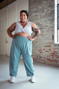 Ashley wears a crop top and blue chanterelle pants
