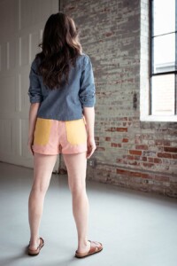 Meredith wears pink and yellow color blocked chanterelle shorts and chambray joanie top