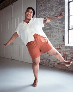 Ashley wearing red chanterelle shorts and a cream Joanie top
