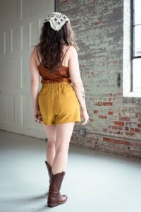 meg wearing yellow chanterelle shorts facing away from the camera