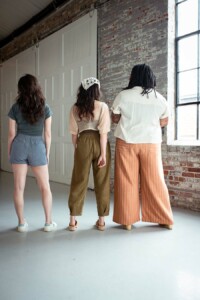 Meredith, Meg and Ashely wearing view c, view b, and view a chanterellas, respectively. They are all smiling.
