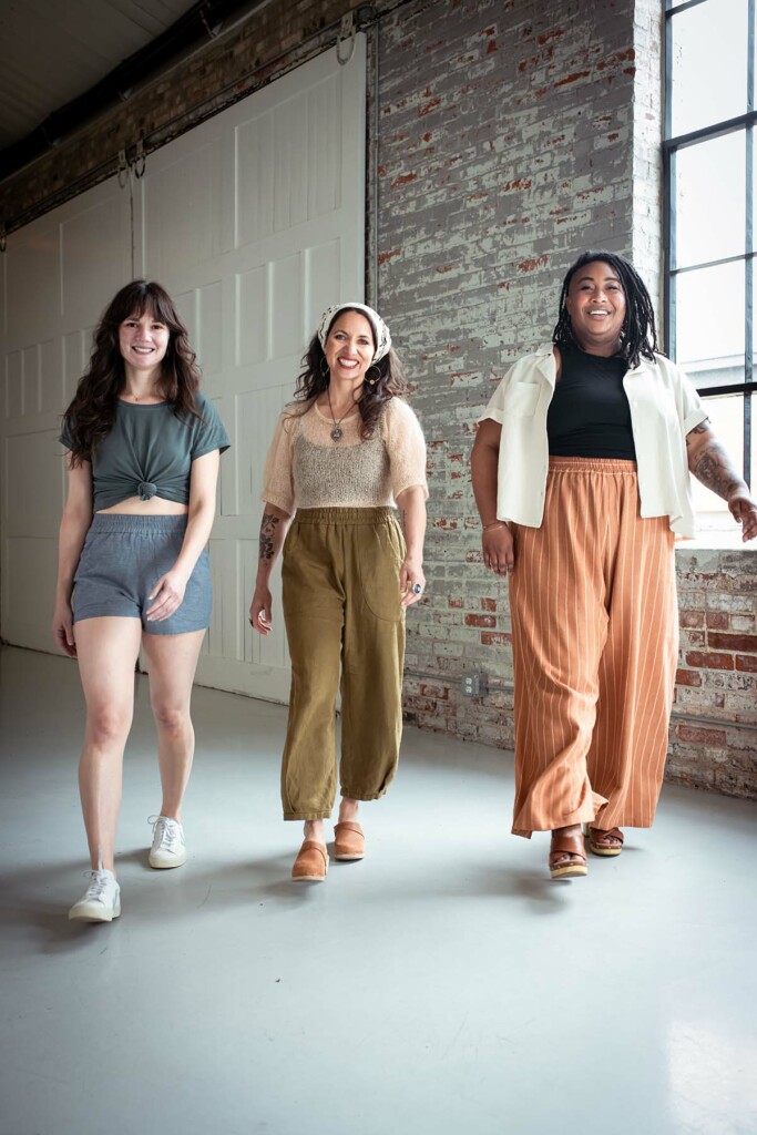 Meredith, Meg and Ashely walk towards the cameras wearing view c, view b, and ciew a chanterellas, respectively. They are all smiling.