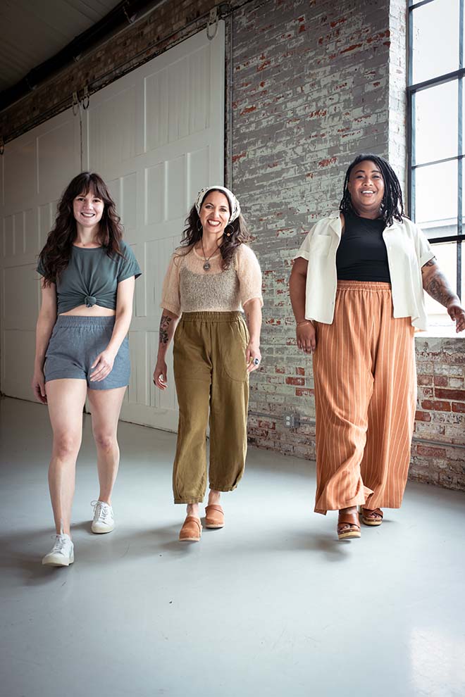 Meredith, Ashley, and Meg walking towards the camera wearing chanterelle Pants and smiling
