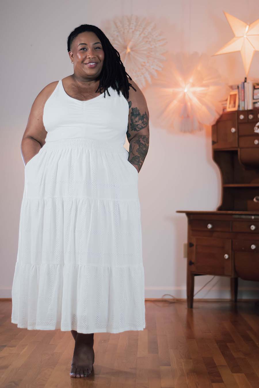 Ashley wears a white songbird skirt and tank top